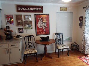 A dining area with two chairs, a small round table, and a coffee machine. - TWO BEDROOM HEATED POOL HOME - FREE CABLE AND WI-FI (Spring Hill)