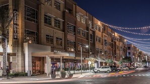 A multi-story hotel with a prominent 'Ocean Prime' sign, outdoor seating area, and string lights. - Secluded Resort Home in N Scottsdale/Cave Creek/Carefree. (Scottsdale)
