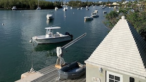 A marina with boats docked, a wooden pier, and a small building with a sign reading "CORAL POINT MARINA". - Charming , Comfortable  Cottage Near Amenities (southampton)