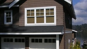 A two-story house with a garage, a small garden, and a clear sky. - 9 AM check in/9 PM check out, Custom Built, no shared walls free standing home (Redmond)