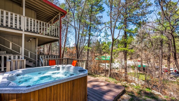 A hot tub on a wooden deck with a two-story building in the background. - RECHARGE,  Pets Welcome,  Fast Wifi,  Opt HOT TUB (Ruidoso)
