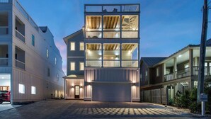 A modern multi-story building with a flat roof, large windows, and a covered front entrance. - Good Day Sunshine | 100 Steps to Beach | 8 Free Beach Chairs through October! | Huge Private Pool & Lush Backyard (Miramar Beach)