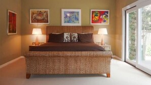 A bedroom with a large bed, two bedside lamps, and three framed artworks on the wall. - Ocean View Retreat in Carmel Meadows w/ Hot Tub. Walk to Trails & Beach! (Carmel)