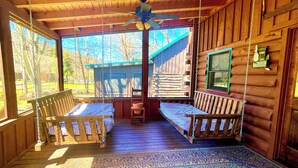 A wooden cabin with a porch, two wooden benches, a ceiling fan, and a welcome sign. - Pet Friendly ☀River Access☀2 bdrm/1 bath☀At Park Entrance☀Screened Porch (Townsend)