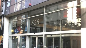 A building with the number 555, labeled as Northbank Place Central Tower. - CityLights apartments (Melbourne)