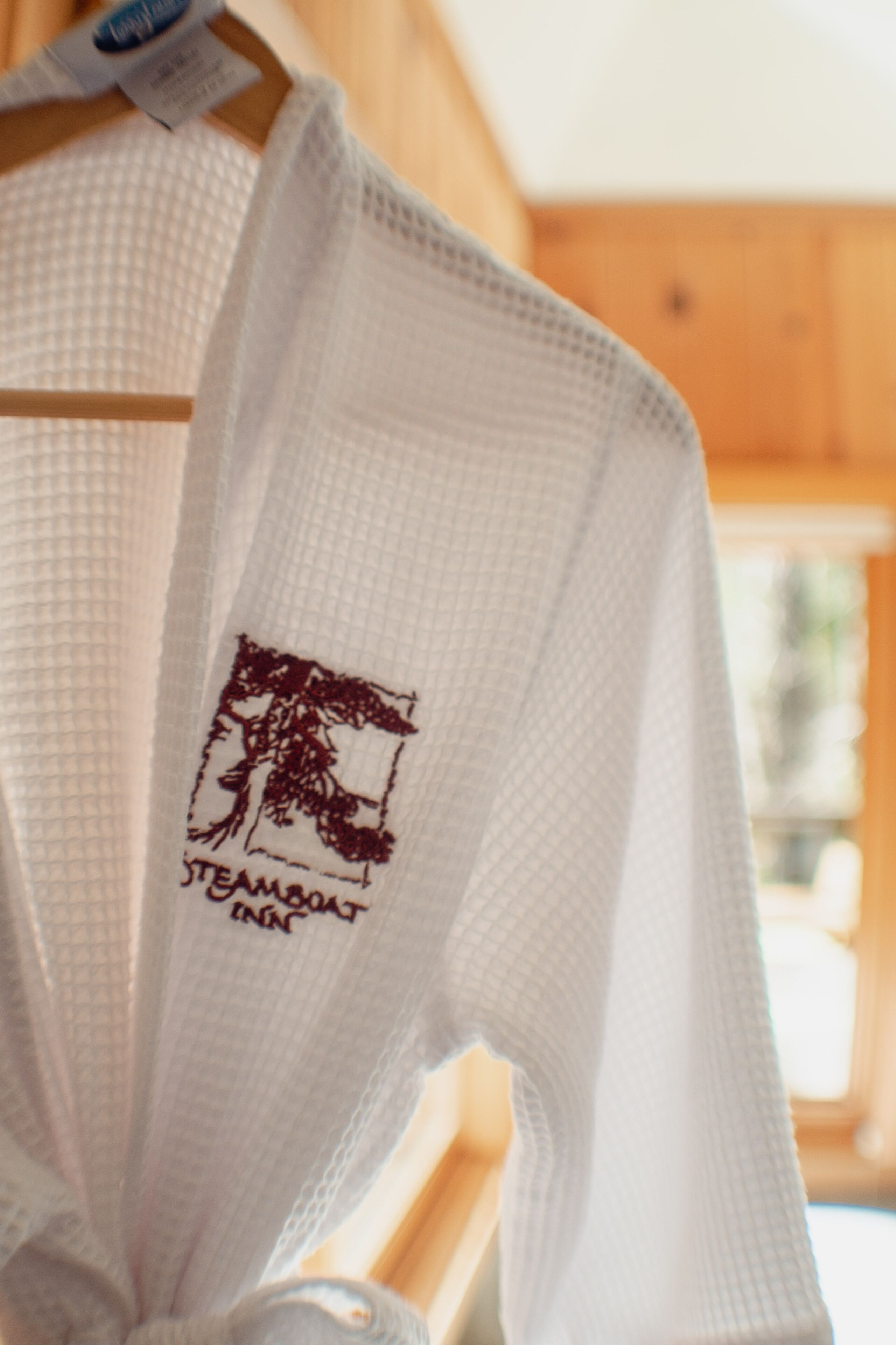 A white towel with a logo and text on it.