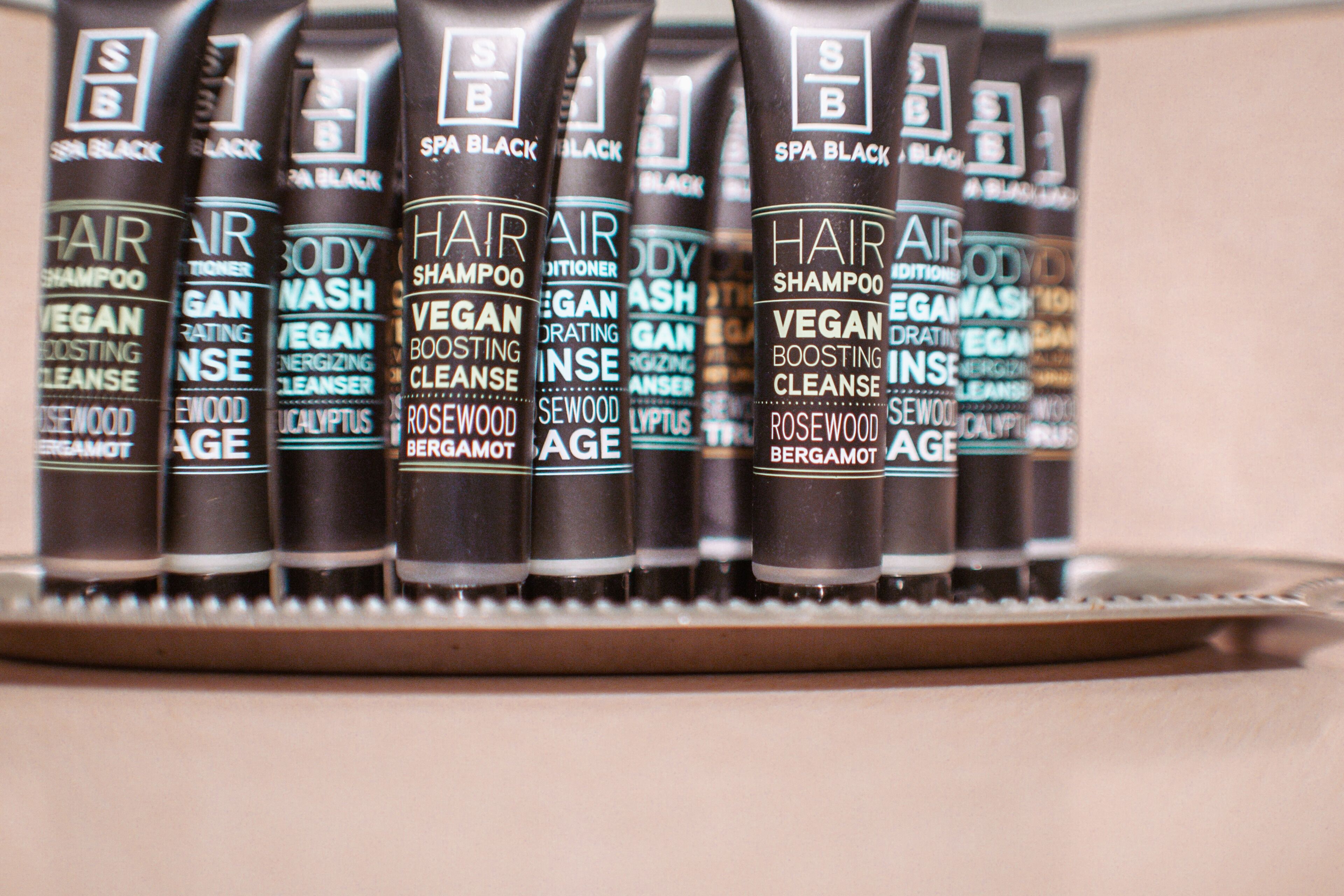 A row of hair care products on a shelf.