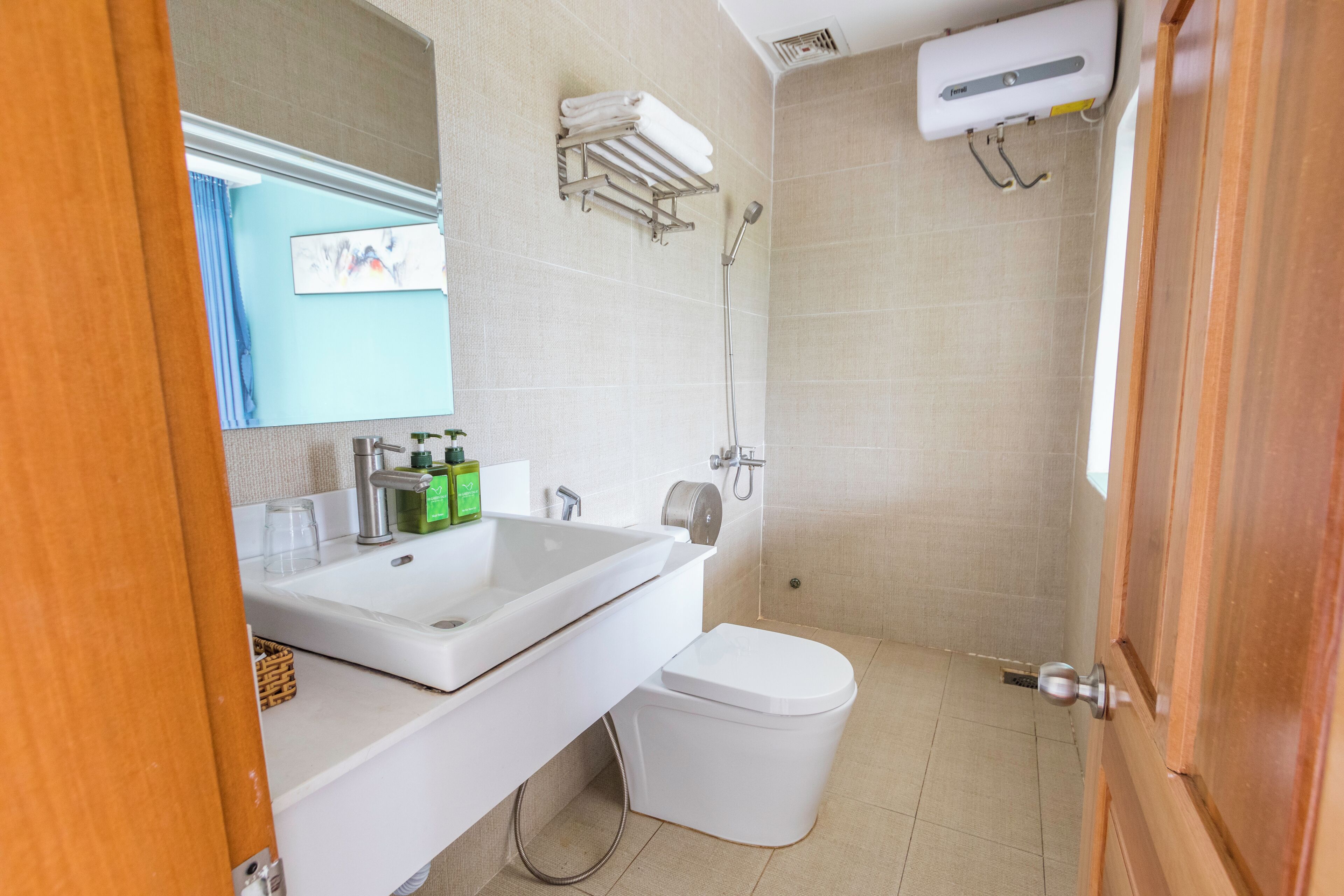 A modern bathroom with a white sink, toilet, and shower.