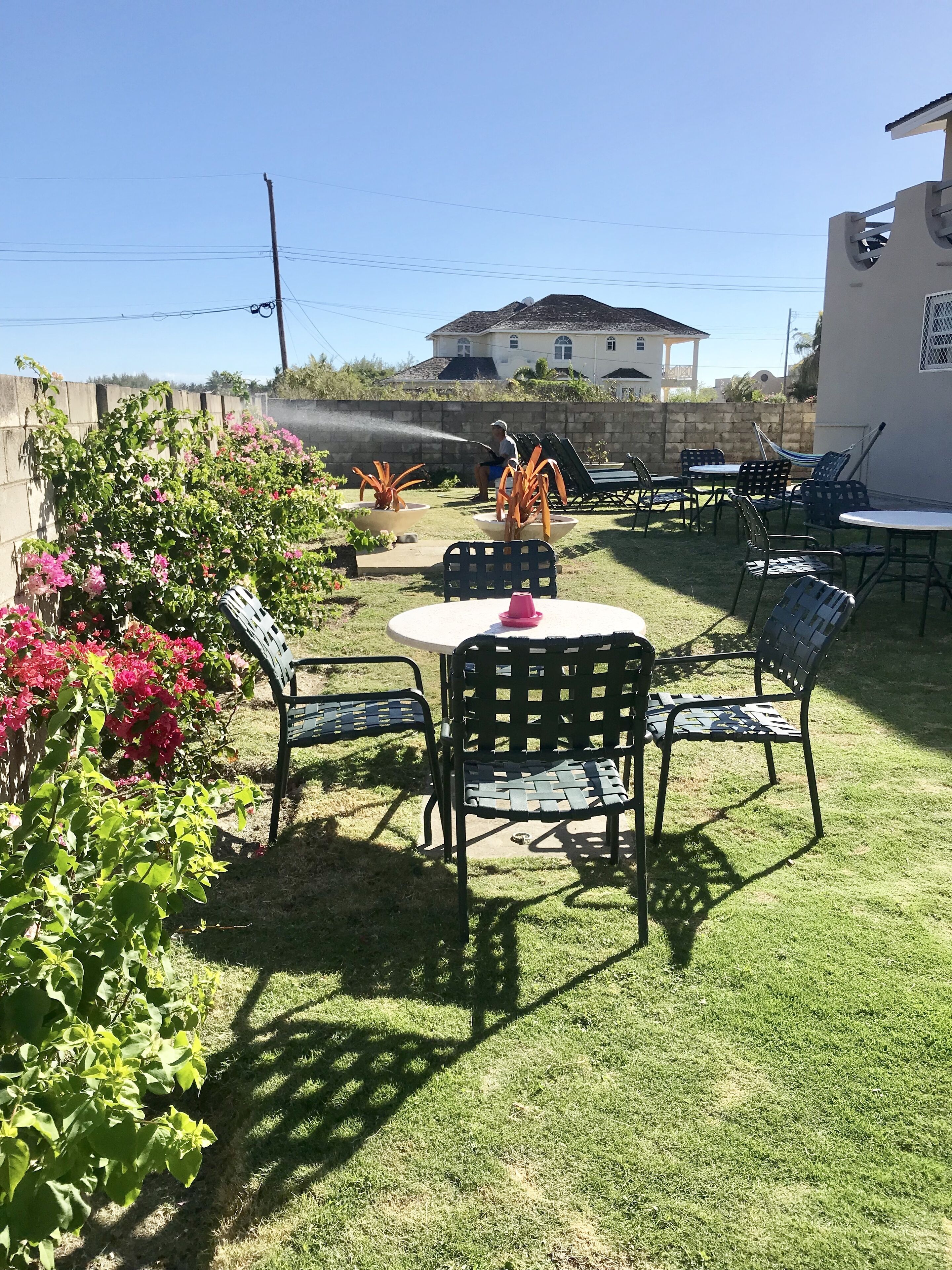 A patio with outdoor furniture, a table, and chairs.