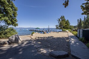 A beach with a wooden walkway, a dock, and boats in the background. - McKinney Cove by Hauserman Rentals (Homewood)