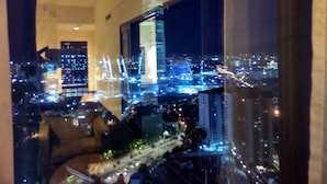 A cityscape view from a high-rise building with illuminated skyscrapers and a clear night sky. - Time Square By Trivaa (Kuala Lumpur)