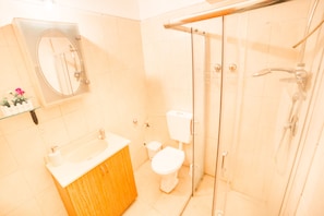 A bathroom with a sink, toilet, and glass shower enclosure. - Premium suites on Beach Ben Yehuda 43 (Tel Aviv)