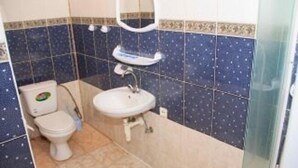 A bathroom with a toilet, sink, and mirror. - Kaufman (Konopnytsia)