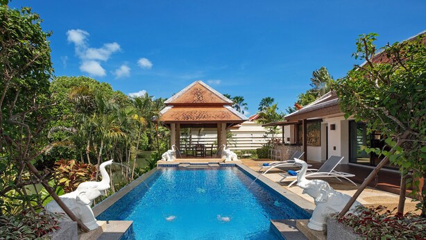 A swimming pool with two swan statues, a gazebo, and lounge chairs. - Boutique 3BR Pool Villa Bianca NaiHarn (Rawai)