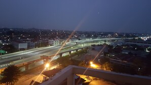 A nighttime cityscape with a multi-level highway and street lighting. - Apartment Bogor Valley (Bogor)