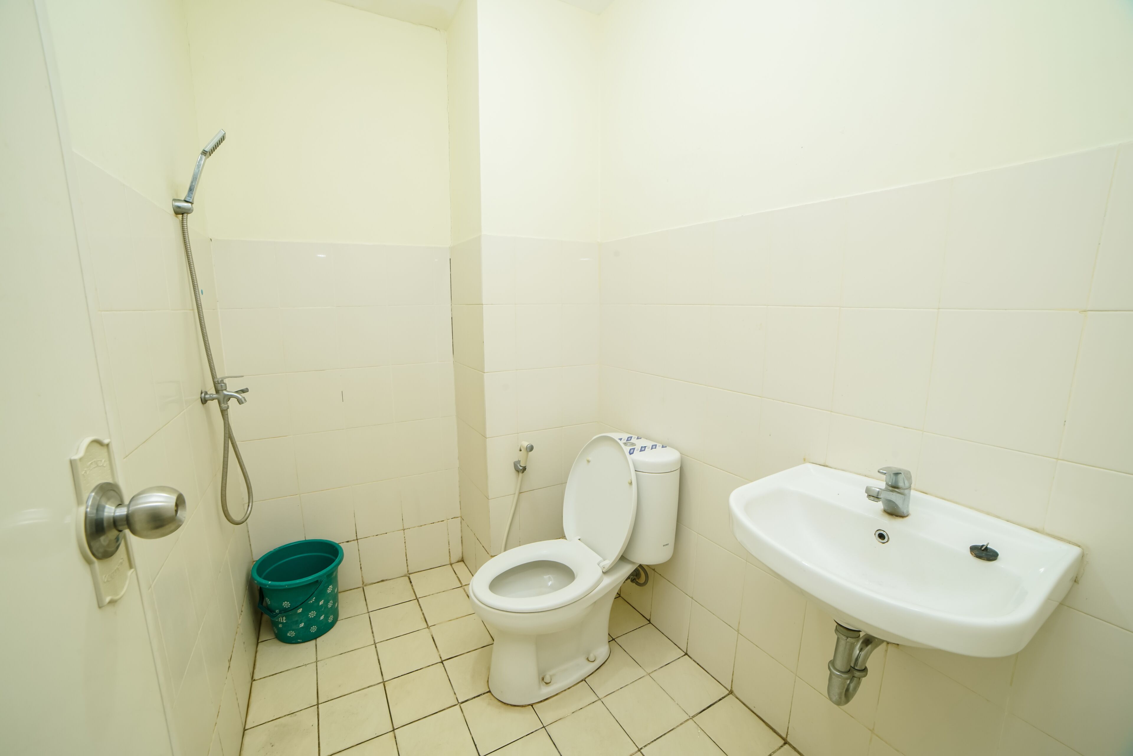 A bathroom with a toilet, a sink, and a shower.