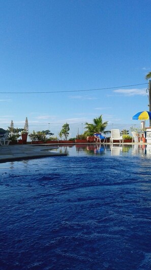 Outdoor pool, open 9:00 AM to 8:00 PM, pool umbrellas