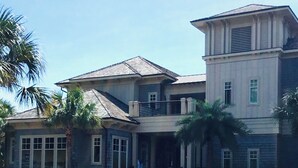 A large, two-story building with a stone facade, multiple windows, and a central entrance.