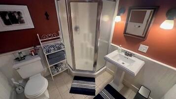 Bathtub, hair dryer, towels, toilet paper