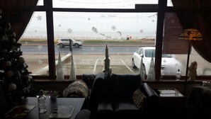A cozy room with a view of the sea, decorated with Christmas ornaments and a Christmas tree. - The Hotel Fame (Blackpool)