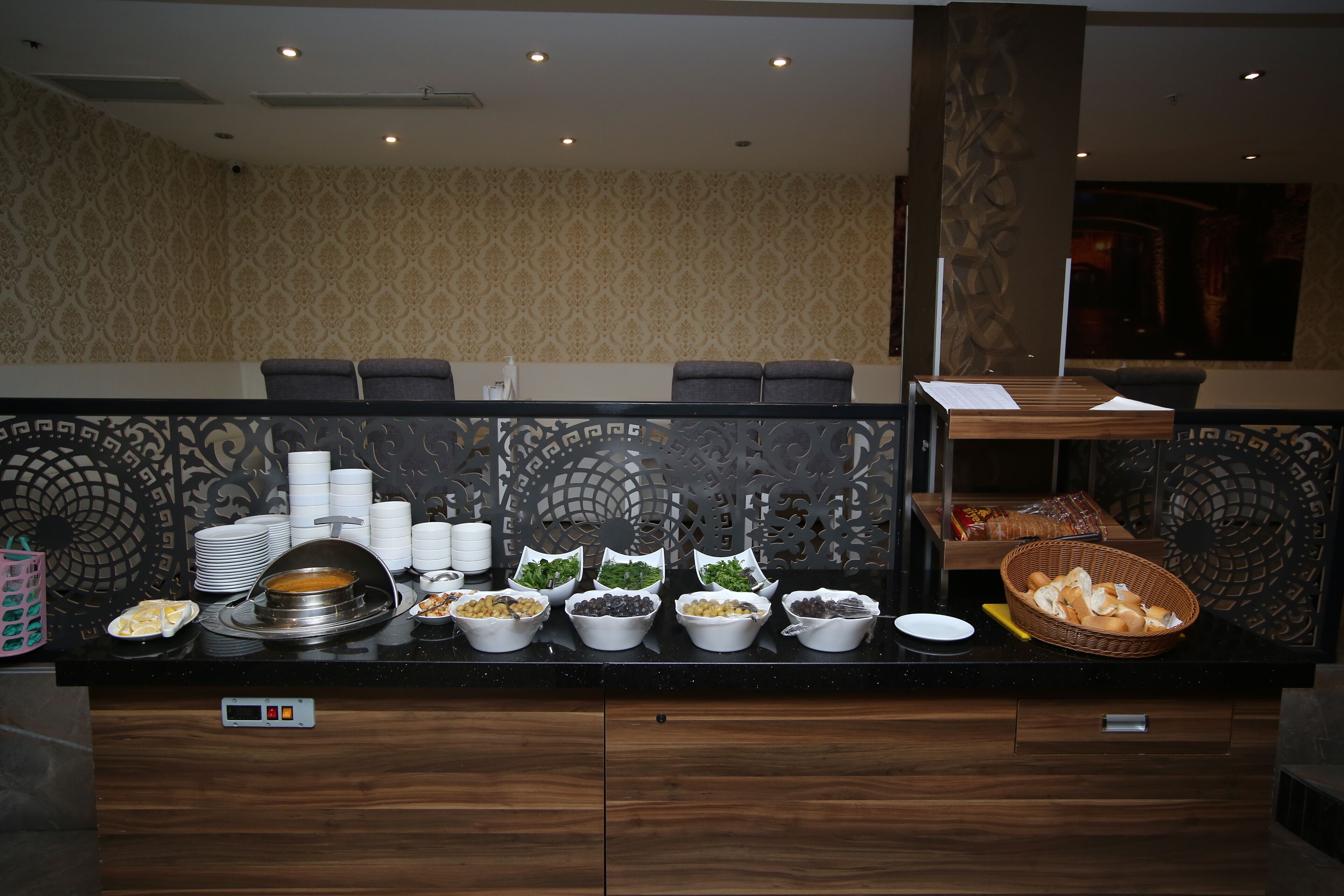 A buffet setup with various food items and a digital control panel.