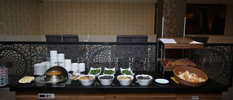 A buffet setup with various food items and a digital control panel.