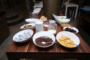 A breakfast buffet with various food items and beverages.