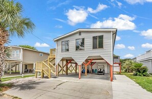 A two-story house with a covered porch and a garage. - SLEEPS 10!  3 bedrms/3 baths/Pier House. One Golf Cart incl. 2nd Cart available (Garden City)