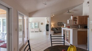 A spacious living area with a dining table, chairs, and a kitchen area with cabinets and appliances. - Piazza Rocca - private acre w/Pool, hot tub, 270 degree mountain views! (Tucson)