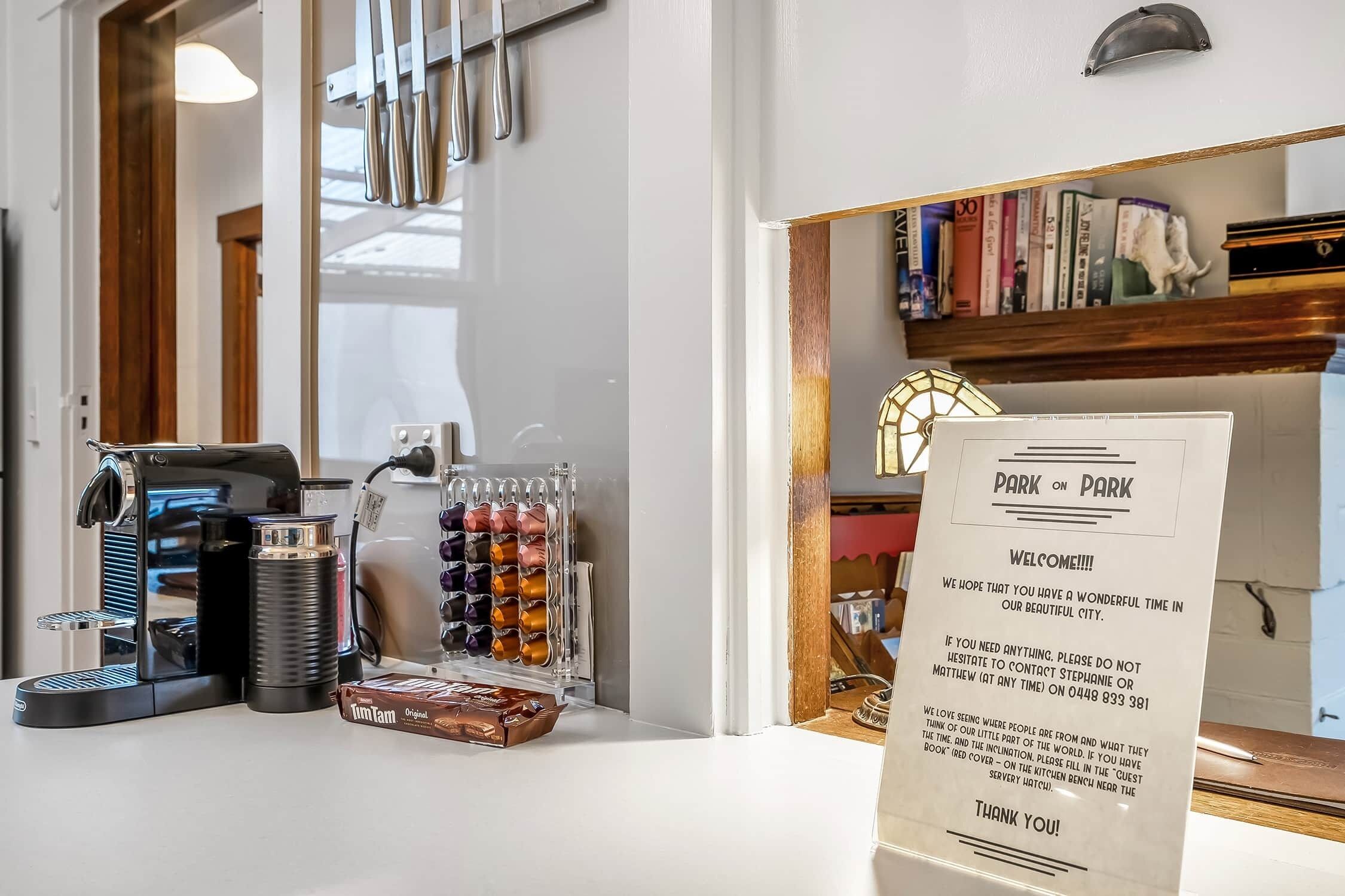 A coffee machine, a glass container with items, and a menu stand with text.