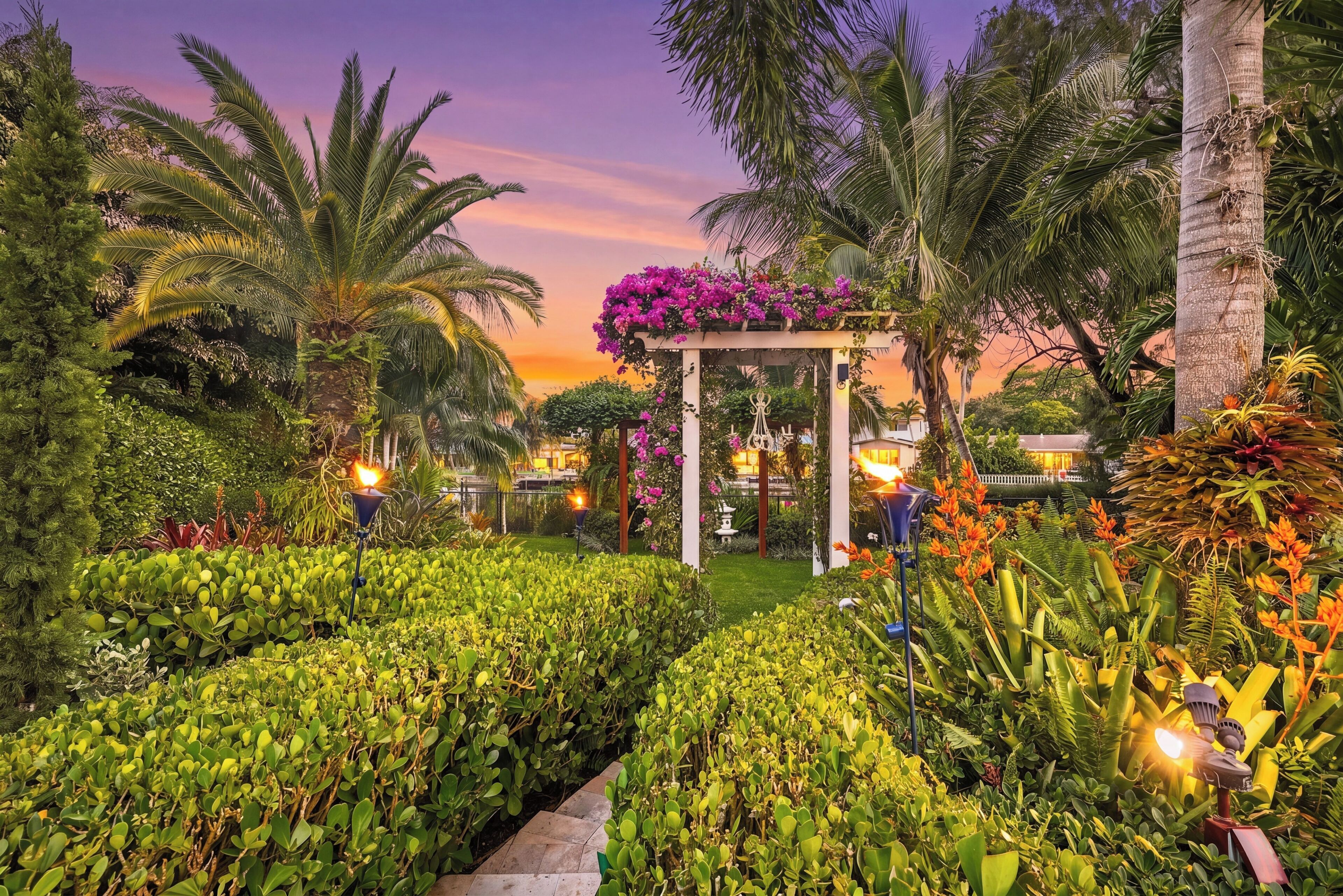 Un jardin agrémenté d’un kiosque, de palmiers et de diverses plantes.