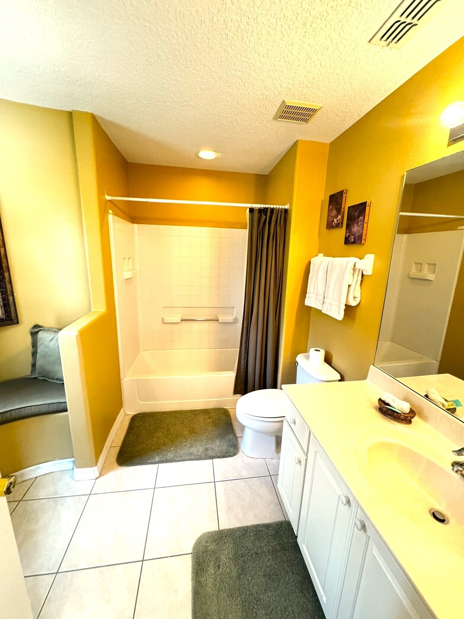 A bathroom with a bathtub, toilet, and sink.