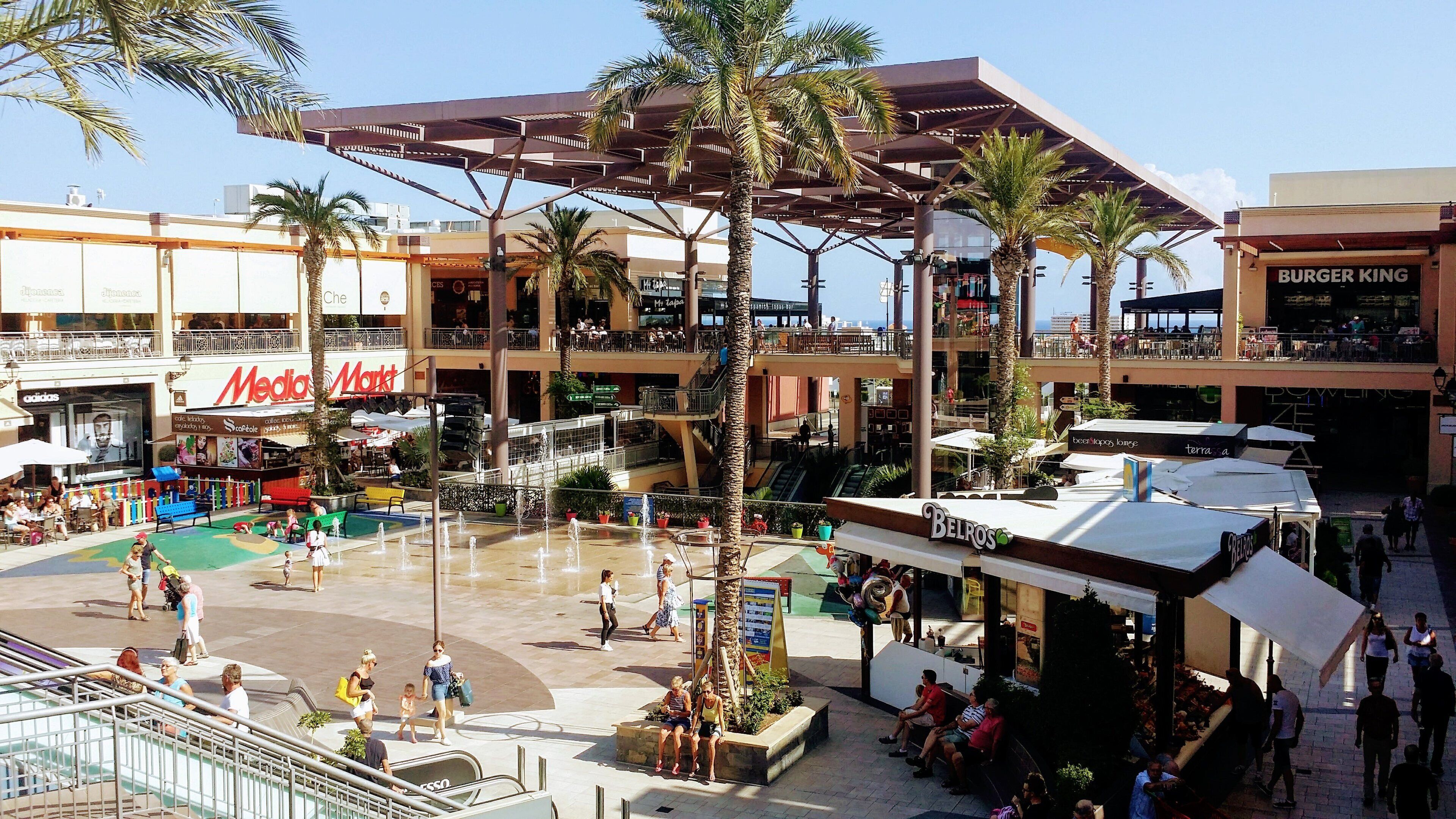 A shopping mall with multiple levels, including a food court area with a Burger King and Belros.