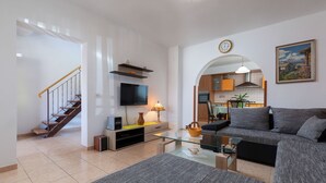 A modern living room with a grey sofa, a glass coffee table, and a TV on a stand. - House / Villa - Rovinj (Rovinj)