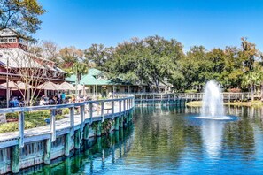 A waterfront restaurant with outdoor seating, a bridge, and a fountain. - NEW PHOTOS! Stylish, Fully Renovated Sea Dunes Condo on Ground Floor! (Fernandina Beach)