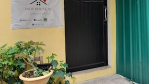 A building with a sign reading "INDY HOUSE 59" and a contact number. - 59 Indy House  (Bangkok)