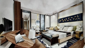 Une chambre moderne avec un grand lit, un bureau et une chaise. Un miroir et un téléviseur sont fixés au mur.