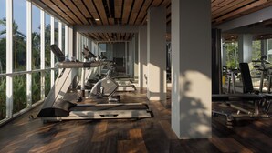 A gym with treadmills, exercise bikes, and weights.