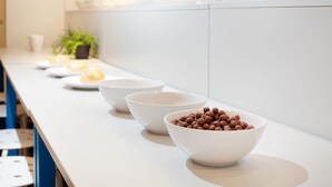 A kitchen counter with white bowls containing different food items. - Hostel Bureau (Zagreb)
