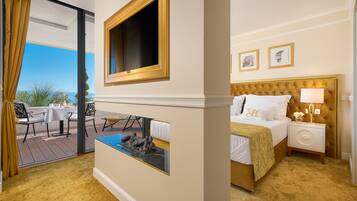 A hotel room with a bed, bedside table, lamp, and a view of the outdoors.