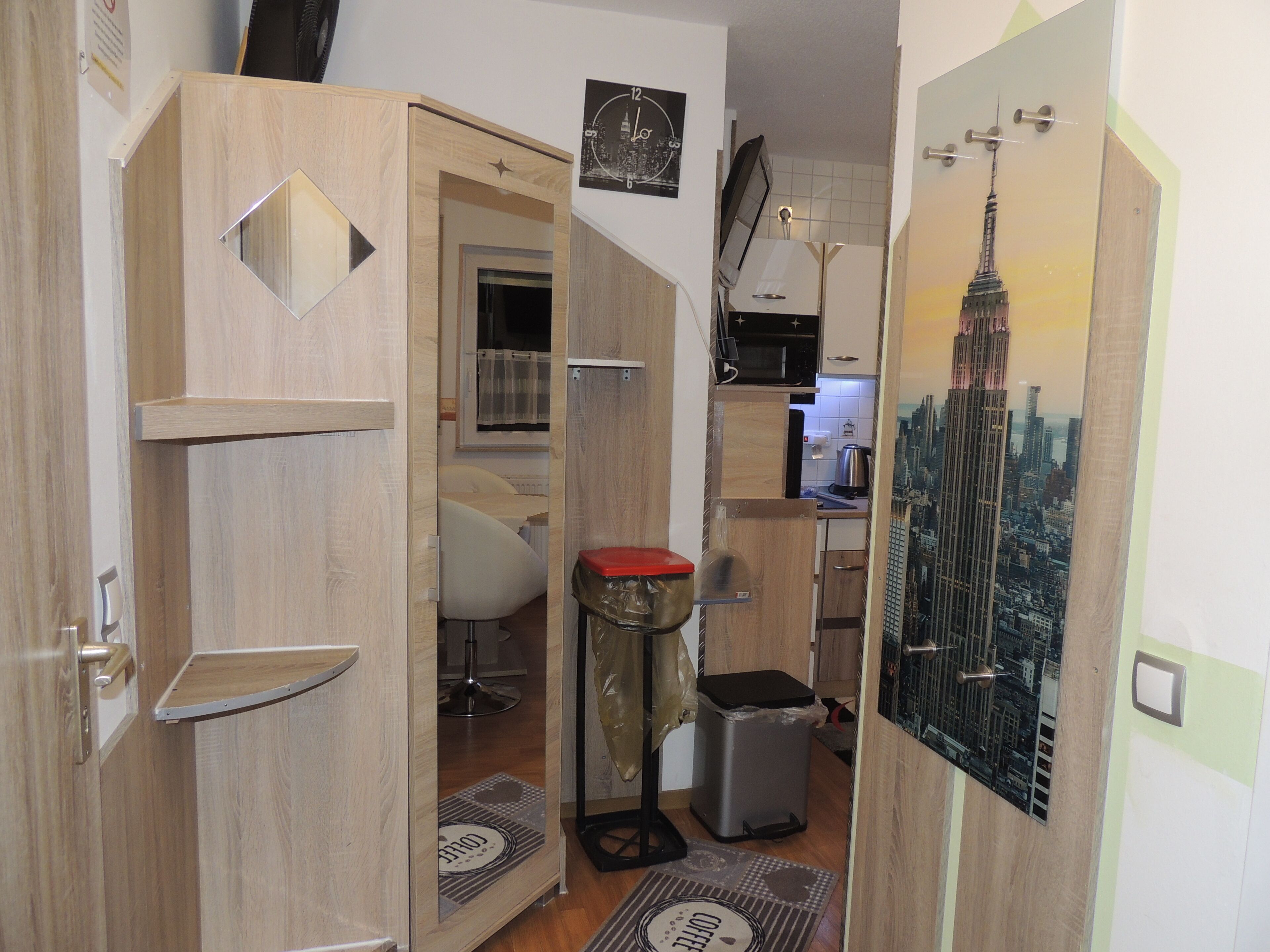 A compact kitchen with wooden cabinets, a microwave, and a sink.