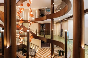 A multi-level interior with a central spiral staircase, a spa sign, and a geometric-patterned floor. - MS Esmeralda Nile Cruise from Aswan or Luxor (Luxor)