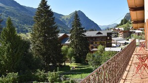 A mountain lodge with a view of the surrounding mountains.