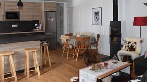 A modern kitchen with wooden cabinets, a built-in microwave, and a black stove.