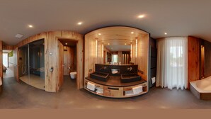 Un baño moderno con tocador de madera, bañera y zona de ducha con mampara de vidrio.