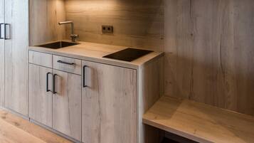 A modern kitchen with wooden cabinetry, a stainless steel sink, and a built-in oven.