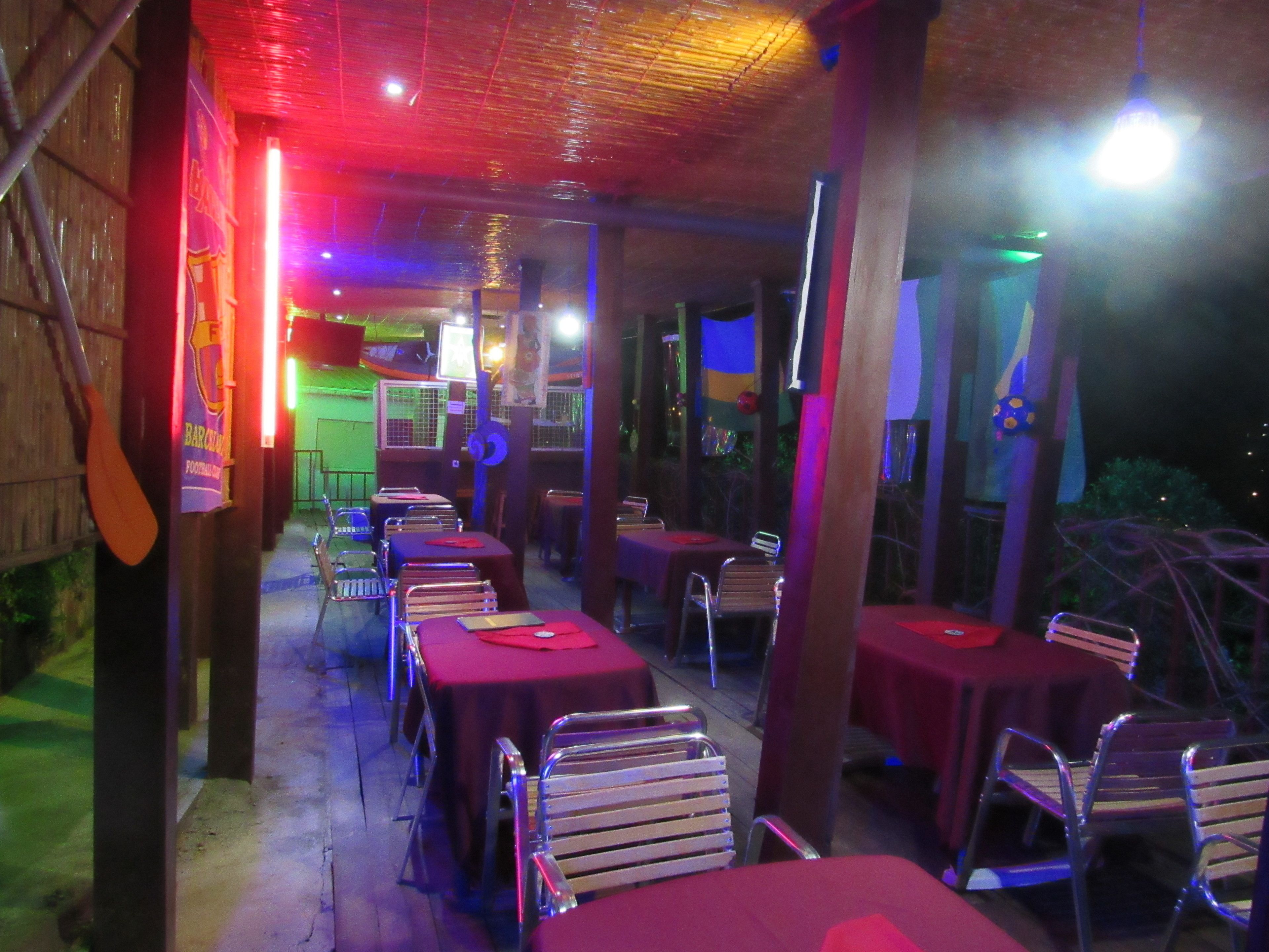 An outdoor restaurant with tables and chairs arranged for dining.