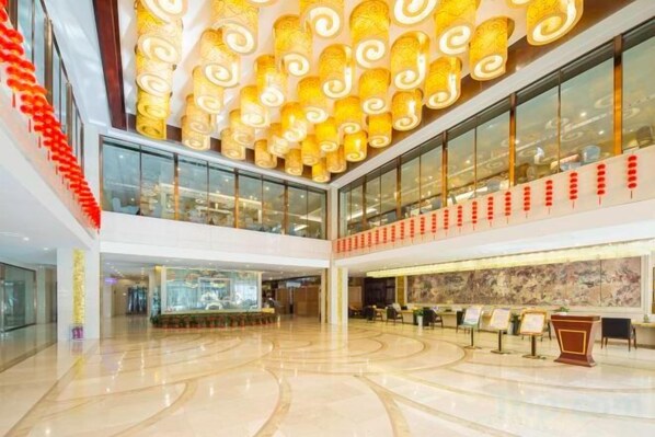 A spacious lobby with a high ceiling, glass railings, and a central seating area. - Taishan Royal Hotel (Tai'an)