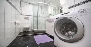 Apartment, 1 Bedroom | Bathroom | Shower, free toiletries, hair dryer, slippers