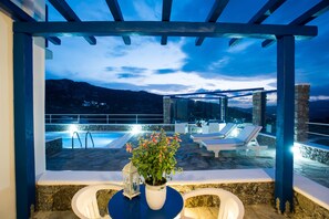 A rooftop pool area with lounge chairs and a potted plant. - Mykonos Pro-care Suites (Mykonos)